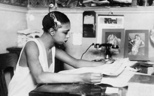 Josephine Baker — Gemini Sun, Mars in Gemini — reading the paper backstage